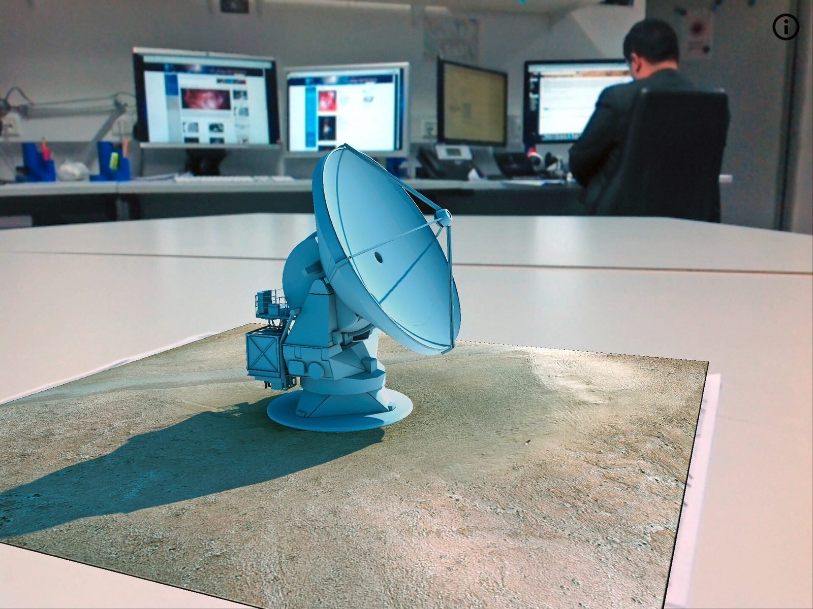 A tablet showing an augmented reality 3D model placed on a desk