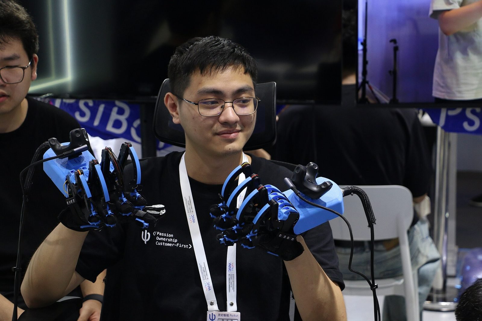 A person wearing a sensor glove controlling a robotic hand